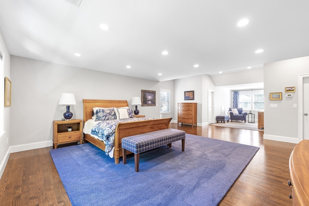 1332 Great Plain Avenue Needham, MA 02492 - Photo 18 of 42 a spacious bedroom with a bed and a wooden floor