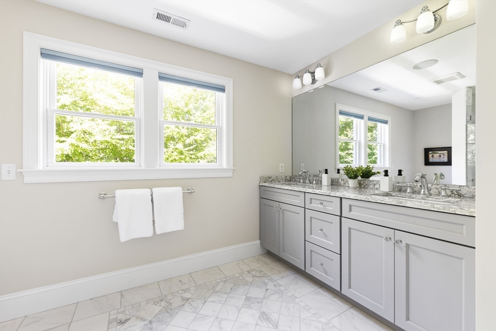1332 Great Plain Avenue Needham, MA 02492 - Photo 20 of 42 a bathroom with a granite countertop sink mirror and a window