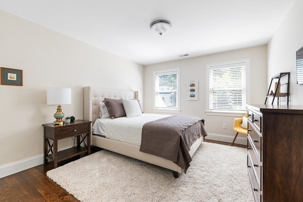 1332 Great Plain Avenue Needham, MA 02492 - Photo 21 of 42 a bedroom with a bed and wooden floor