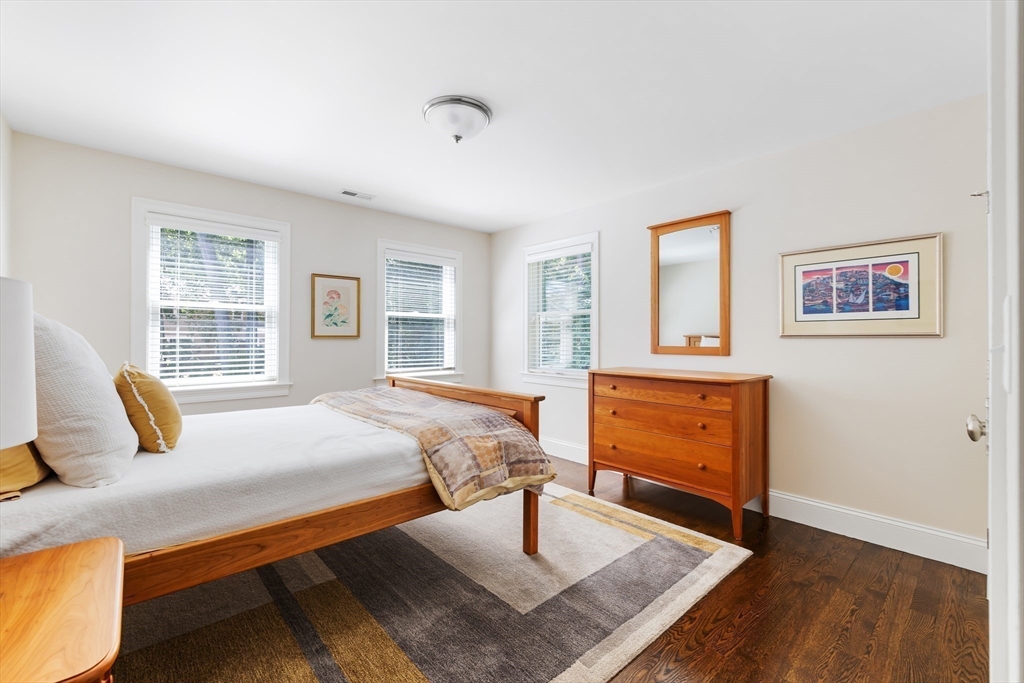 1332 Great Plain Avenue Needham, MA 02492 - Photo 22 of 42 a bedroom with a bed a dresser and wooden floor