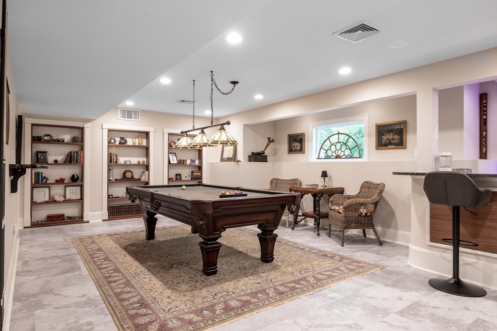 1332 Great Plain Avenue Needham, MA 02492 - Photo 24 of 42 a living room with furniture a dining table and a rug