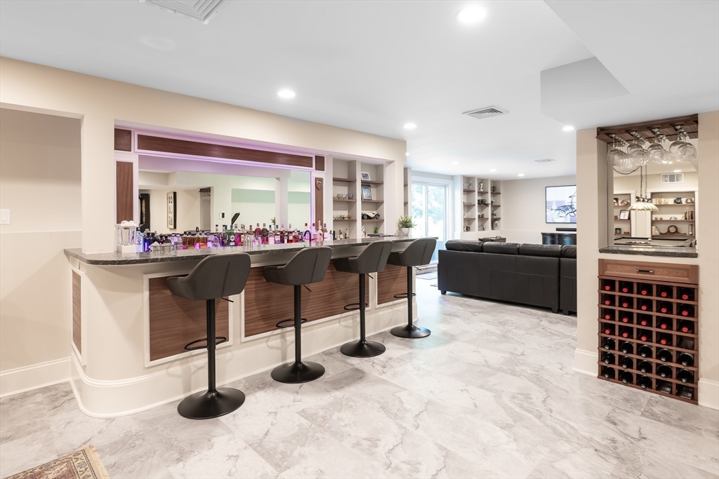 1332 Great Plain Avenue Needham, MA 02492 - Photo 25 of 42 a living room with furniture a dining table and kitchen view