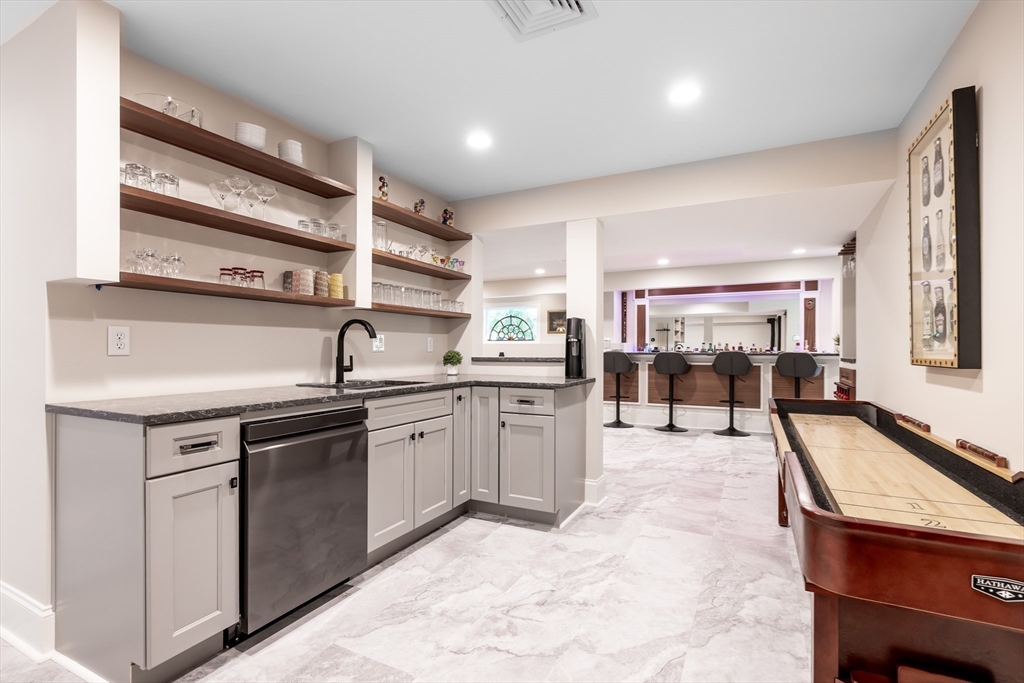 1332 Great Plain Avenue Needham, MA 02492 - Photo 26 of 42 a kitchen with a sink stove and cabinets