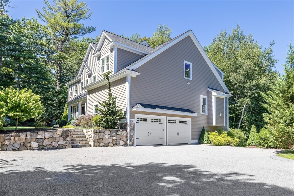 1332 Great Plain Avenue Needham, MA 02492 - Photo 32 of 42 a front view of a house with a yard and garage