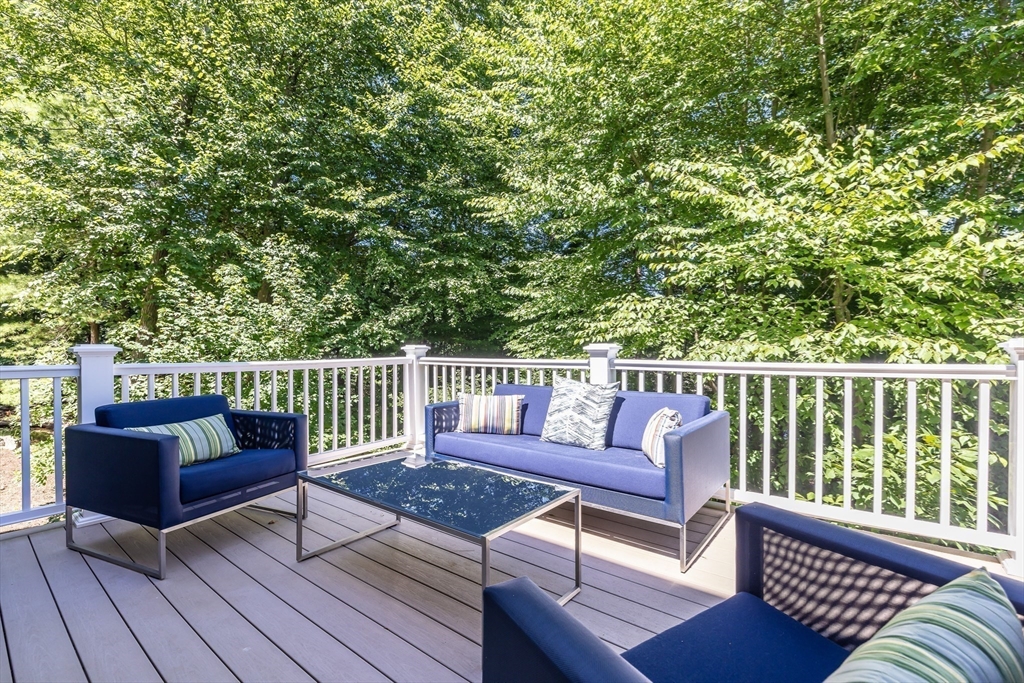1332 Great Plain Avenue Needham, MA 02492 - Photo 34 of 42 a roof deck with couches and wooden floor