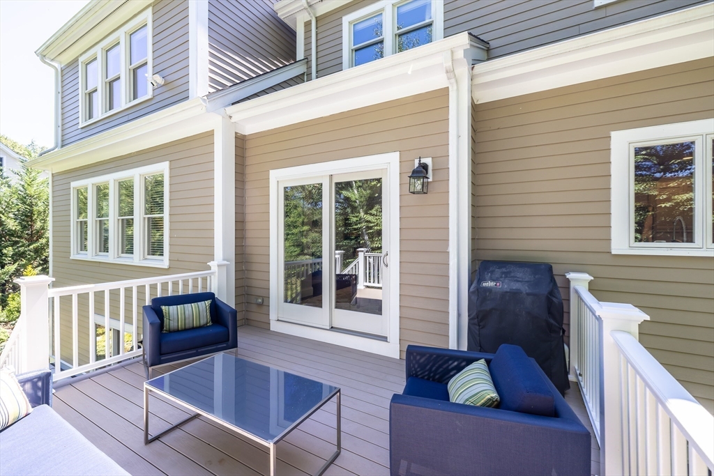 1332 Great Plain Avenue Needham, MA 02492 - Photo 36 of 42 a balcony view with a couch and wooden floor