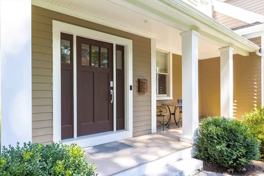 1332 Great Plain Avenue Needham, MA 02492 - Photo 38 of 42 a view of a brick house with large windows and plants