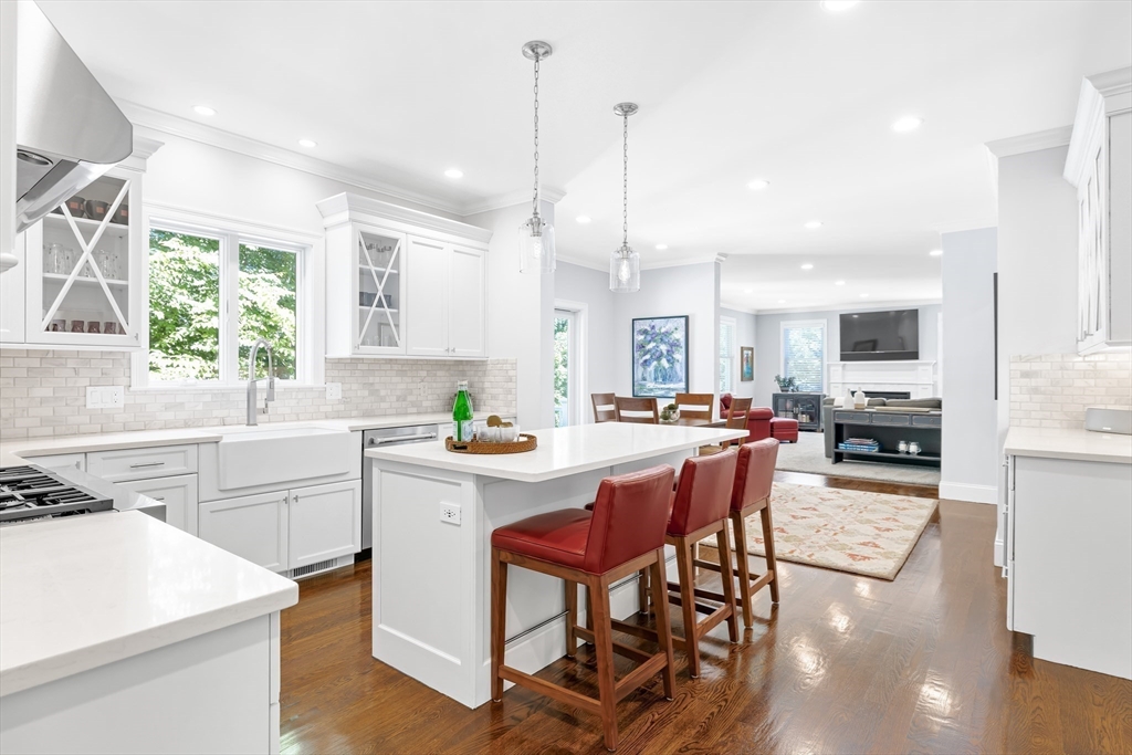 1332 Great Plain Avenue Needham, MA 02492 - Photo 5 of 42 a kitchen with stainless steel appliances kitchen island a large window a sink and a refrigerator