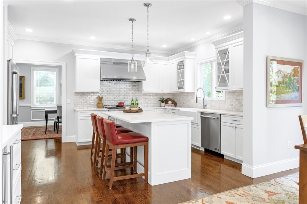 1332 Great Plain Avenue Needham, MA 02492 - Photo 6 of 42 a kitchen with a table chairs sink and cabinets