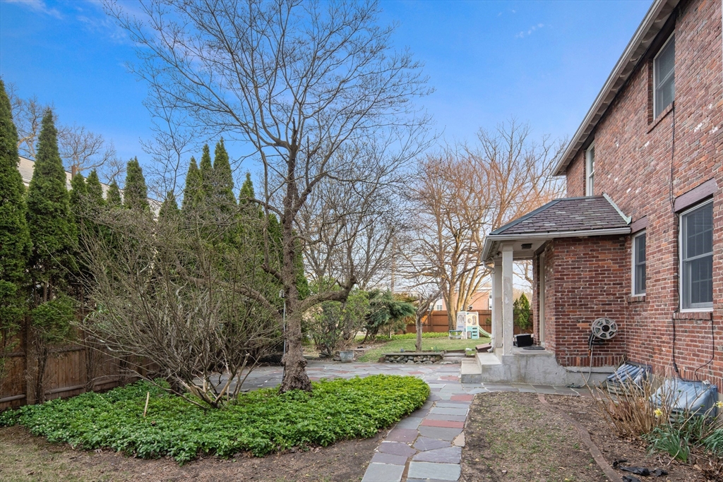 5 Evelyn Road Newton, MA 02468 - Photo 18 of 21 a brick house with trees in front of it