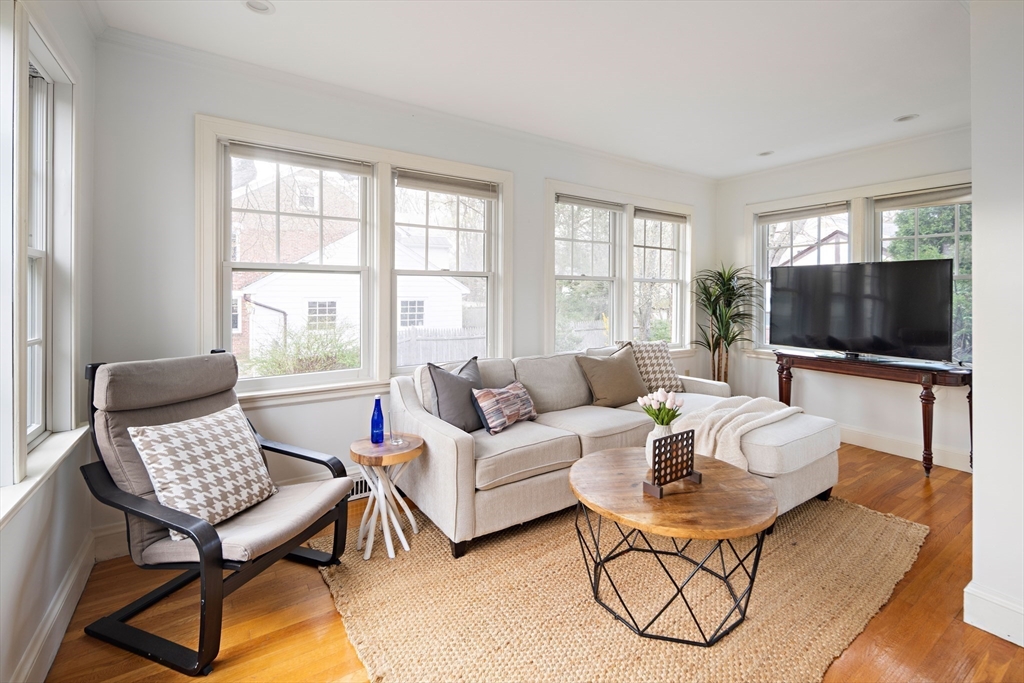 5 Evelyn Road Newton, MA 02468 - Photo 5 of 21 a living room with furniture a flat screen tv and a window