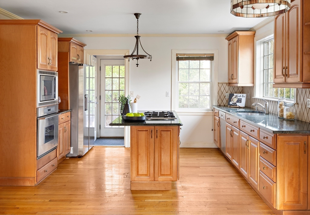 5 Evelyn Road Newton, MA 02468 - Photo 6 of 21 a large kitchen with stainless steel appliances granite countertop a stove a sink dishwasher a refrigerator and wooden floor