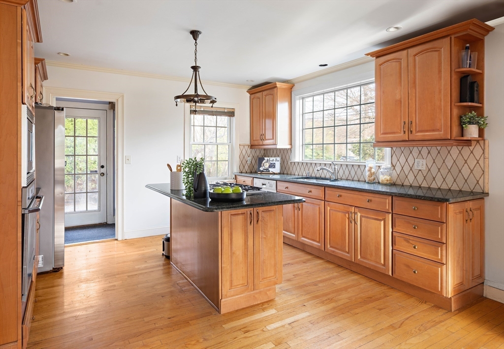 5 Evelyn Road Newton, MA 02468 - Photo 7 of 21 a kitchen with stainless steel appliances granite countertop wooden floors and sink