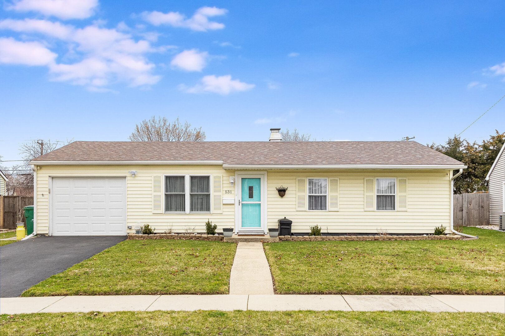 a view of a yard in front of a house with garage