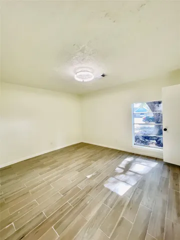 a view of a room with wooden floor