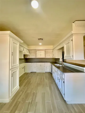 a kitchen with stainless steel appliances granite countertop a refrigerator a stove and a sink