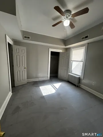 a view of empty room with ceiling fan