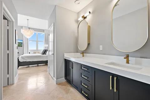 a en suite bathroom with a double vanity sink double and mirror