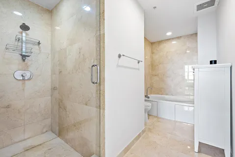 a bathroom with a bathtub and a shower
