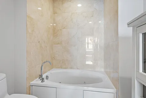 a bathroom with a bathtub and a toilet