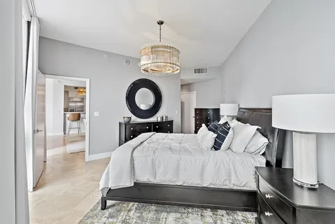 a bedroom with a bed lamp closet and window