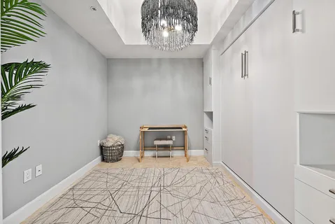 a bedroom with a bed and a potted plant