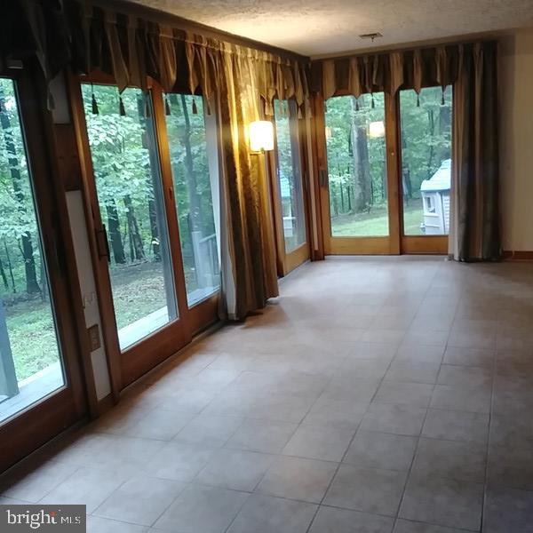 4010 Stumptown Road Taneytown, MD 21787 - Photo 22 of 26 Glass enclosed Sun Porch overlooking wooded lot.