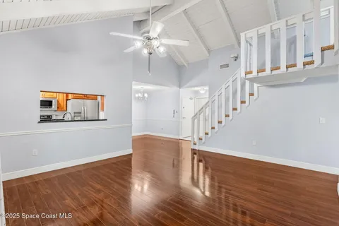 a view of staircase with wooden floor and fan