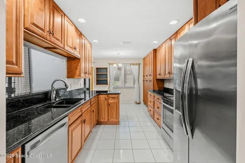 a kitchen with stainless steel appliances granite countertop a sink and a stove top oven
