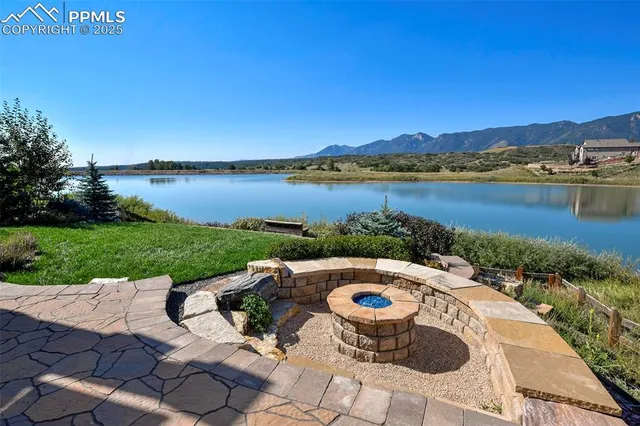a view of a lake with couches and city view