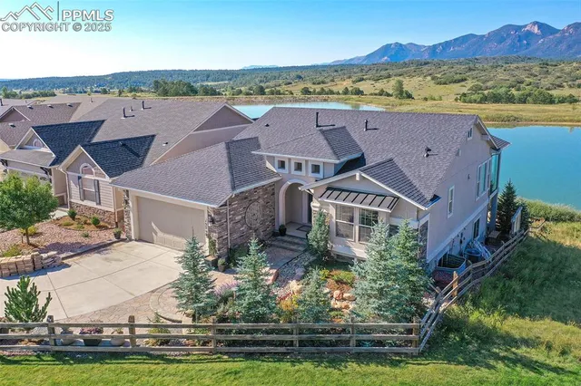 an aerial view of house with yard swimming pool and mountains