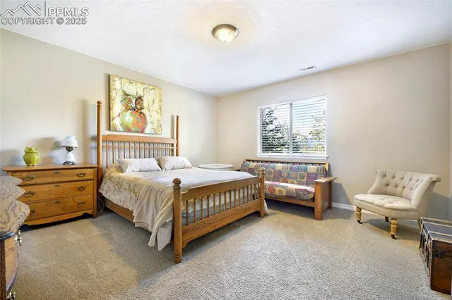 a spacious bedroom with a bed and a window