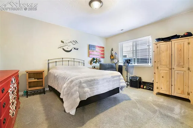 a spacious bedroom with a bed and cabinets