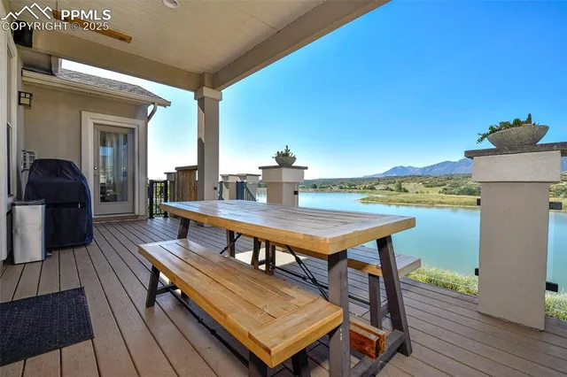 a terrace with wooden floor table and chairs