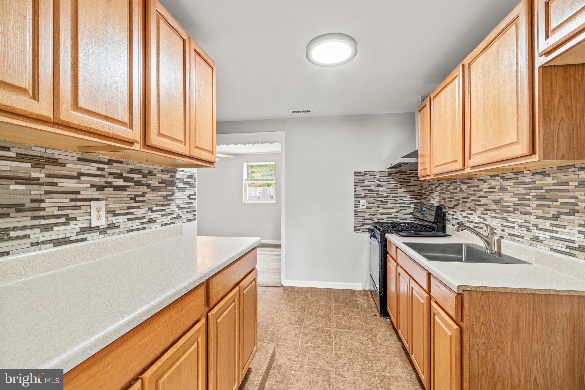 176 Lemmon Avenue Pemberton, NJ 08068 - Photo 11 of 20 a kitchen with stainless steel appliances granite countertop a sink and a stove