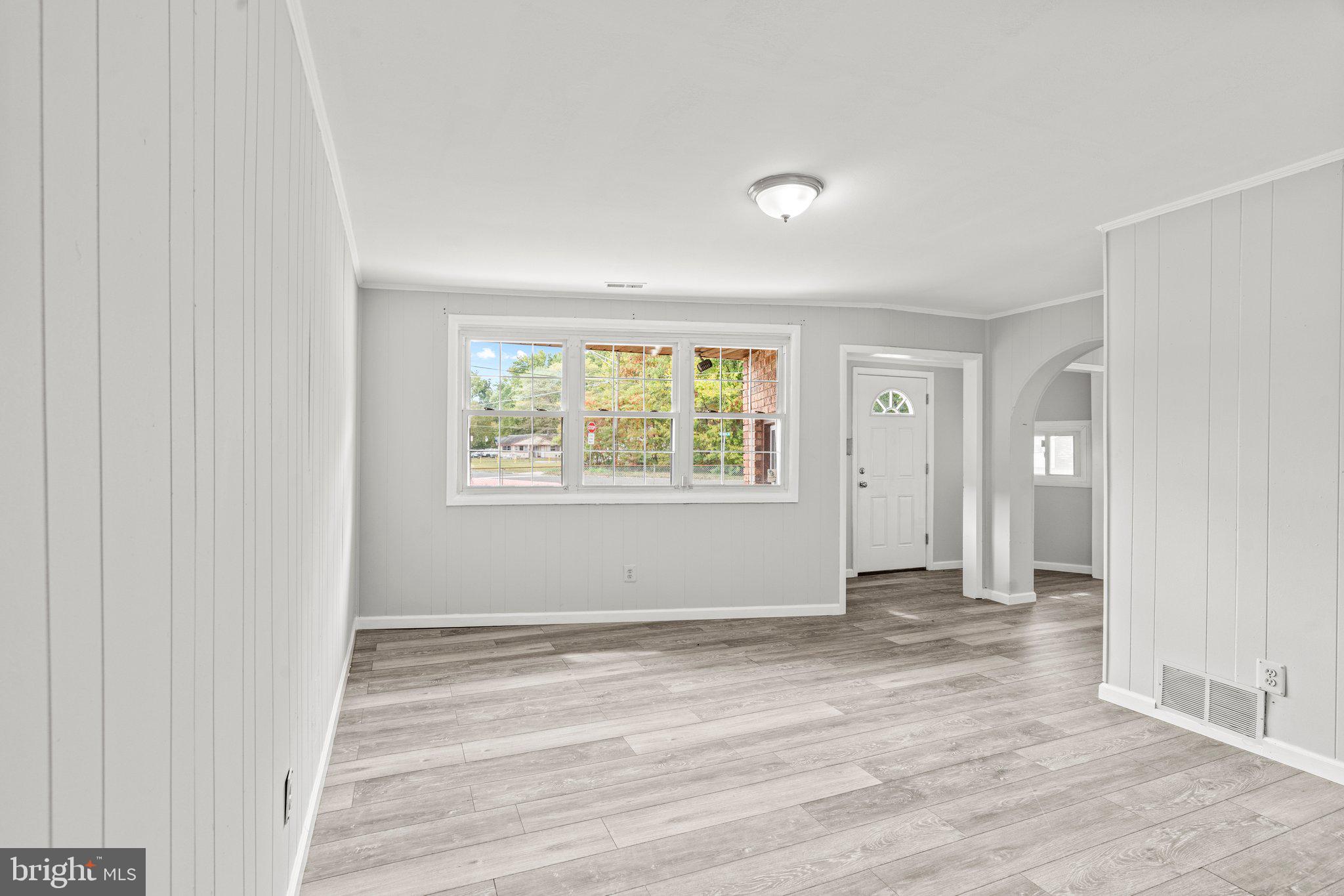 176 Lemmon Avenue Pemberton, NJ 08068 - Photo 12 of 20 an empty room with wooden floor and windows