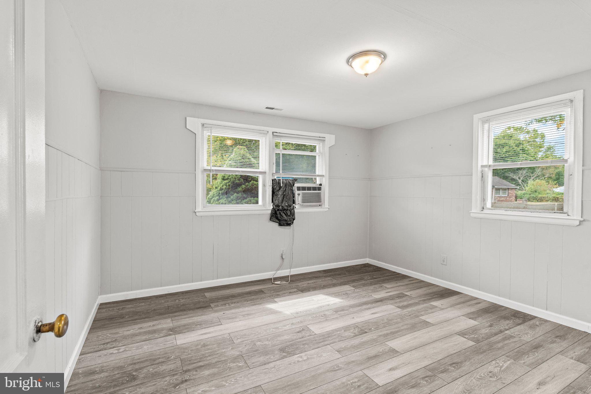 176 Lemmon Avenue Pemberton, NJ 08068 - Photo 16 of 20 an empty room with wooden floor and windows