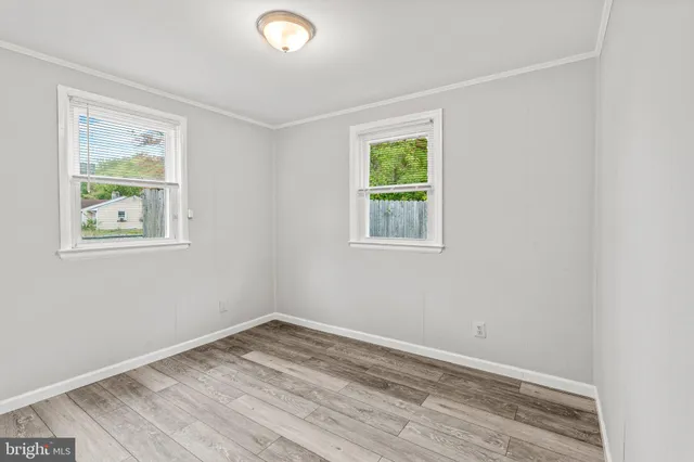 a bathroom with a granite countertop sink toilet and mirror