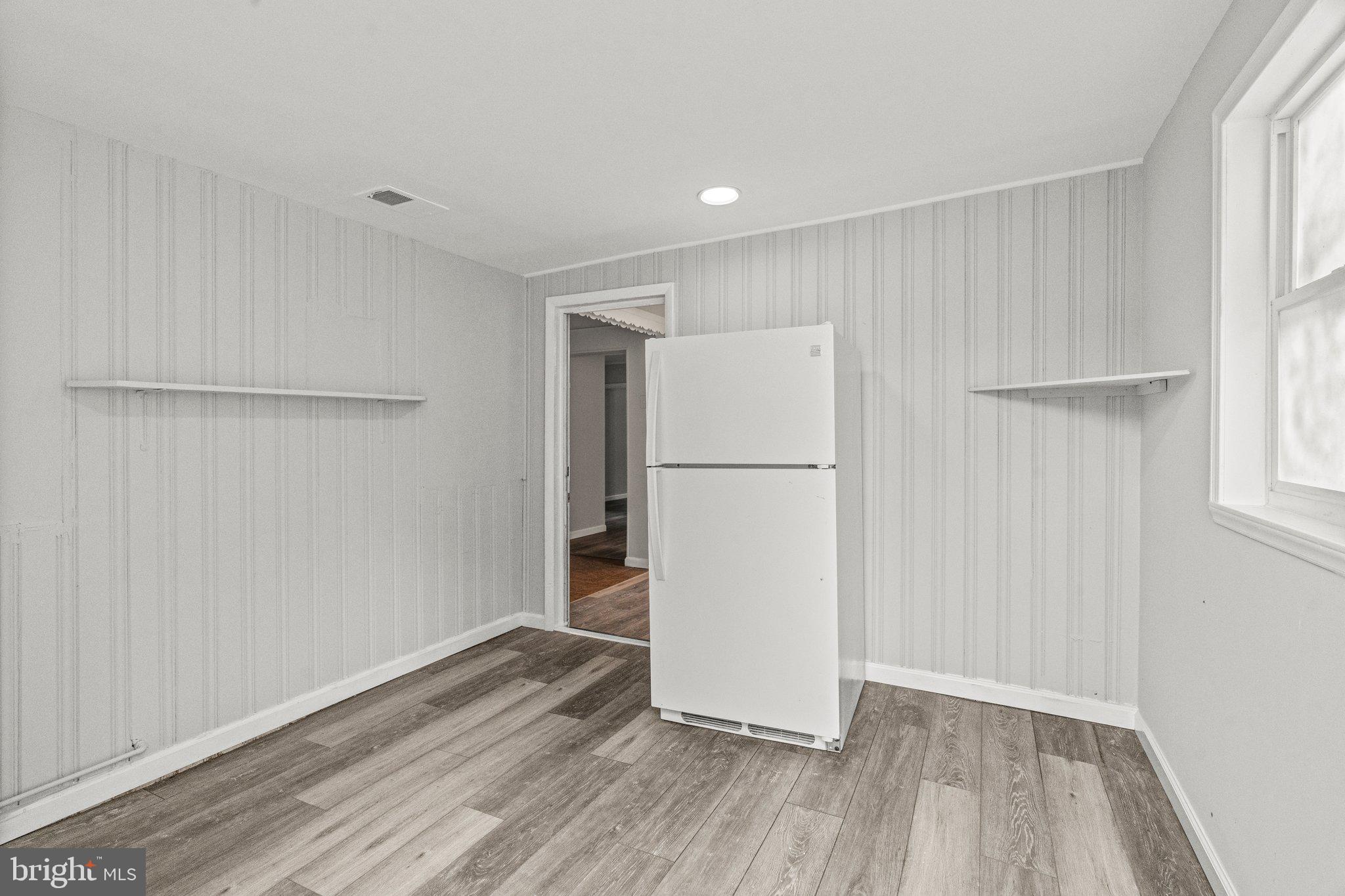 176 Lemmon Avenue Pemberton, NJ 08068 - Photo 19 of 20 a view of a room with wooden floor and a refrigerator