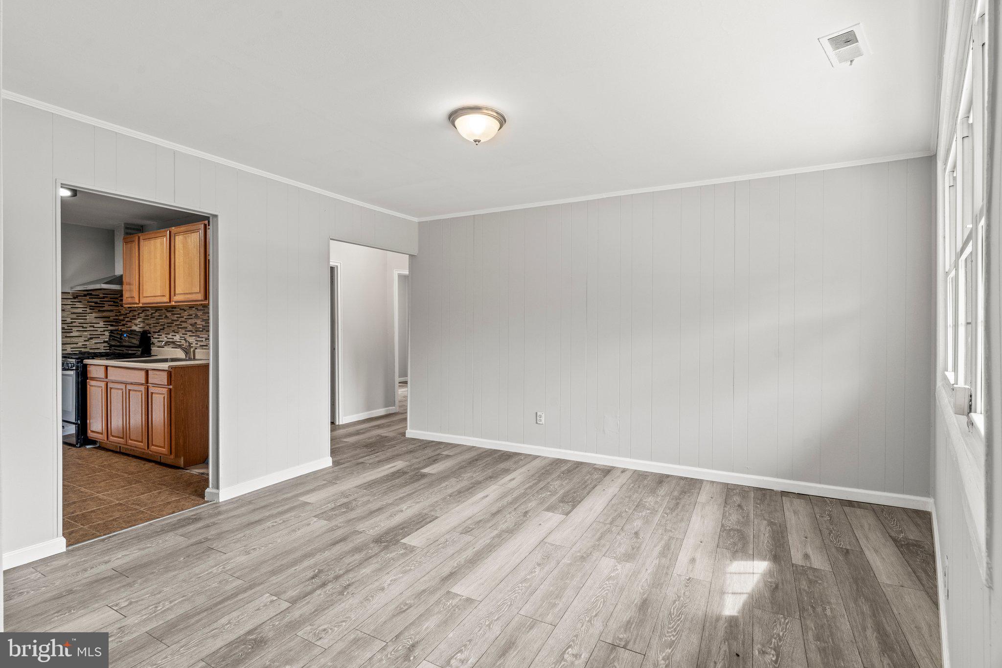 176 Lemmon Avenue Pemberton, NJ 08068 - Photo 3 of 20 a view of an empty room with kitchen and a window
