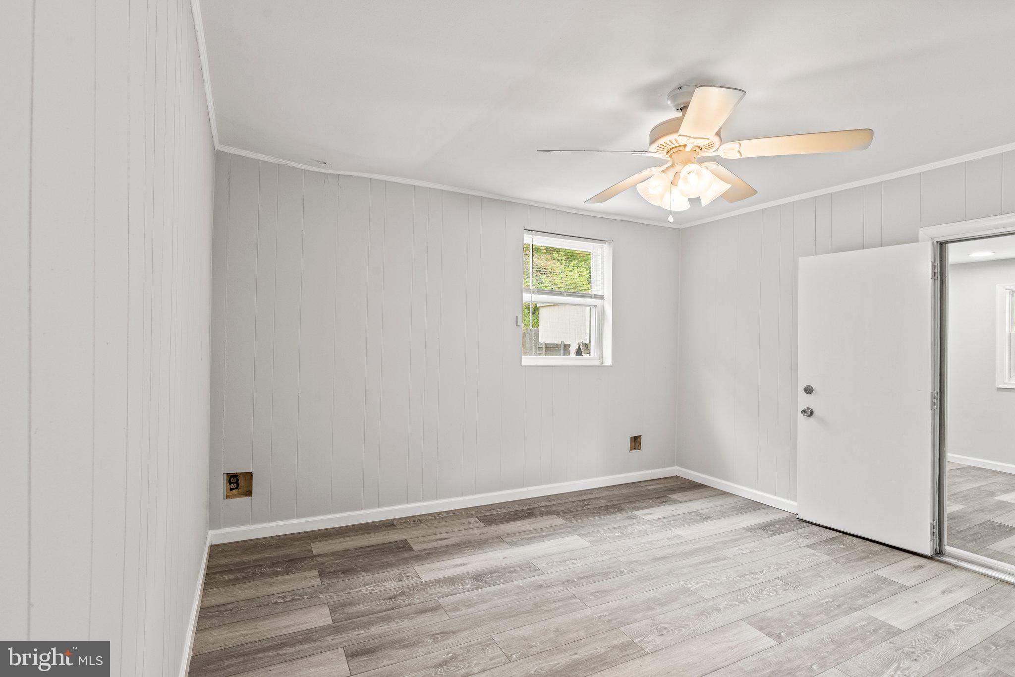 176 Lemmon Avenue Pemberton, NJ 08068 - Photo 8 of 20 an empty room with a window and wooden floor