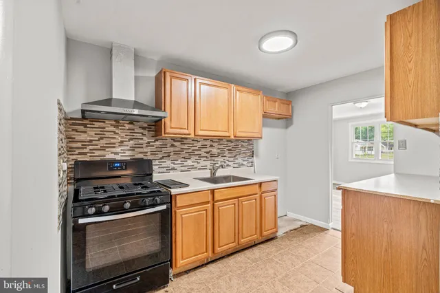 a kitchen with granite countertop cabinets stainless steel appliances and a window