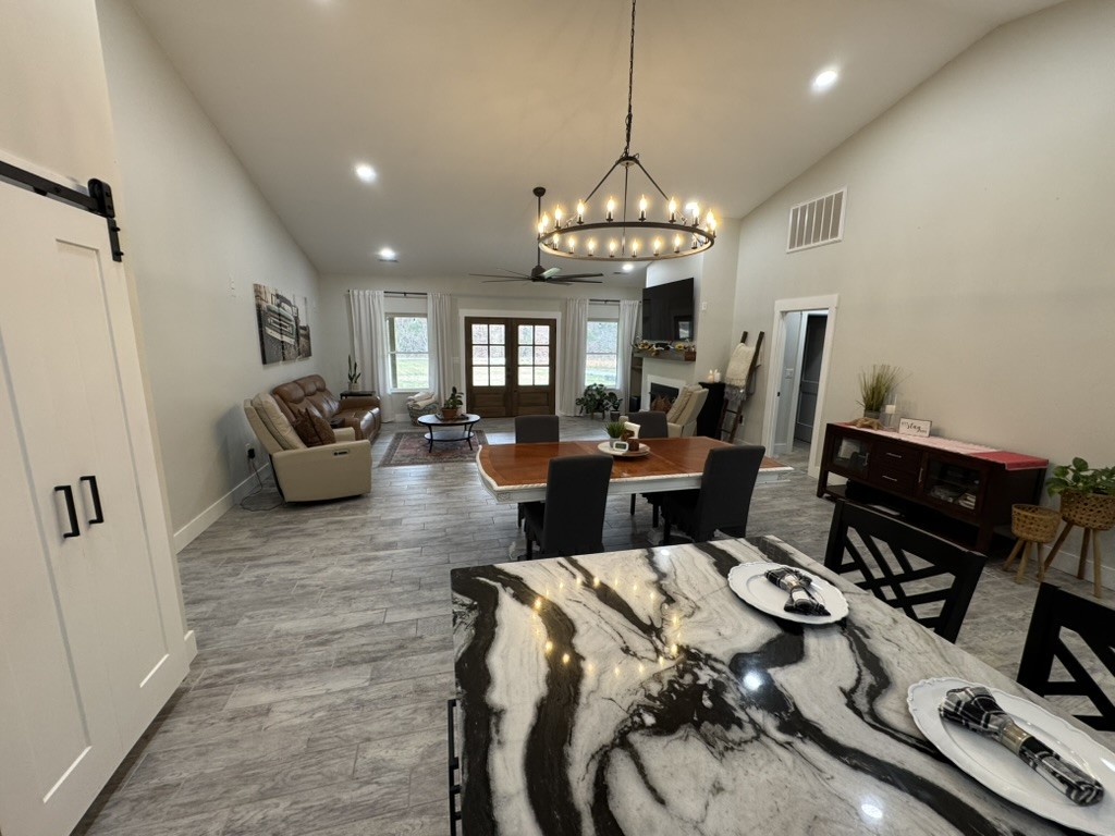 767 Potter Road Dickson, TN 37055 - Photo 12 of 30 a view of a livingroom with furniture a chandelier and wooden floor