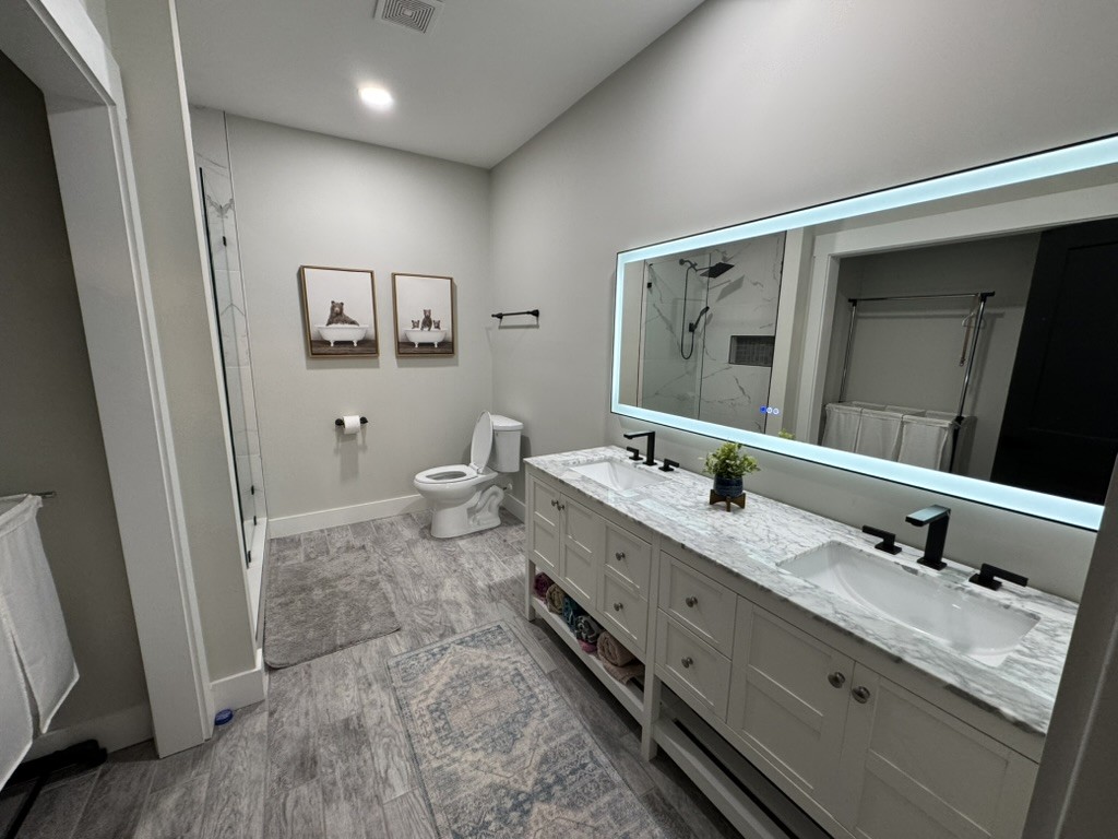 767 Potter Road Dickson, TN 37055 - Photo 23 of 30 a spacious bathroom with a double vanity sink and a mirror