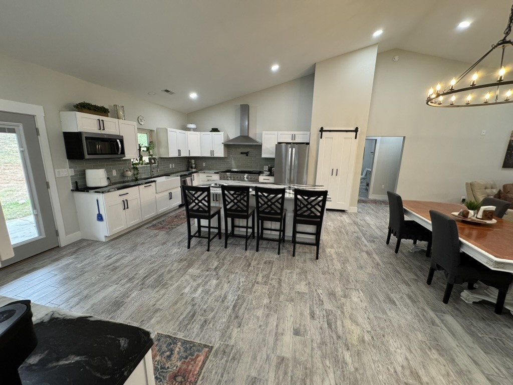 767 Potter Road Dickson, TN 37055 - Photo 8 of 30 a view of kitchen with kitchen island stainless steel appliances wooden floor dining table and chairs