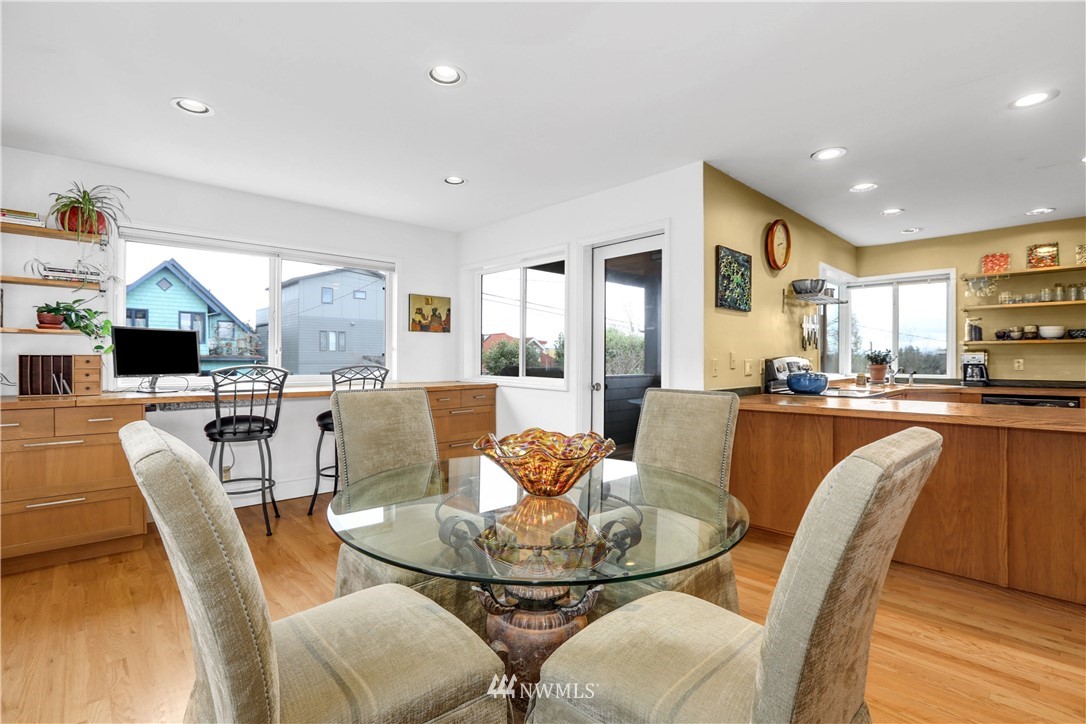 2418 East Roy Street Seattle, WA 98112 - Photo 11 of 32 a dining room with furniture a window and kitchen view