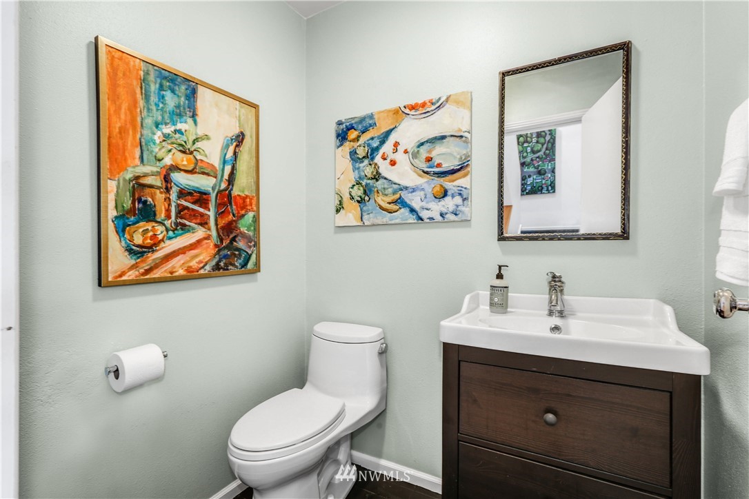 2418 East Roy Street Seattle, WA 98112 - Photo 15 of 32 a bathroom with a toilet a sink and mirror