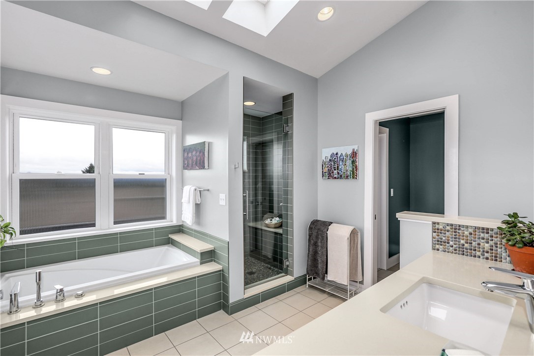 2418 East Roy Street Seattle, WA 98112 - Photo 19 of 32 a bathroom with a tub sink and mirror
