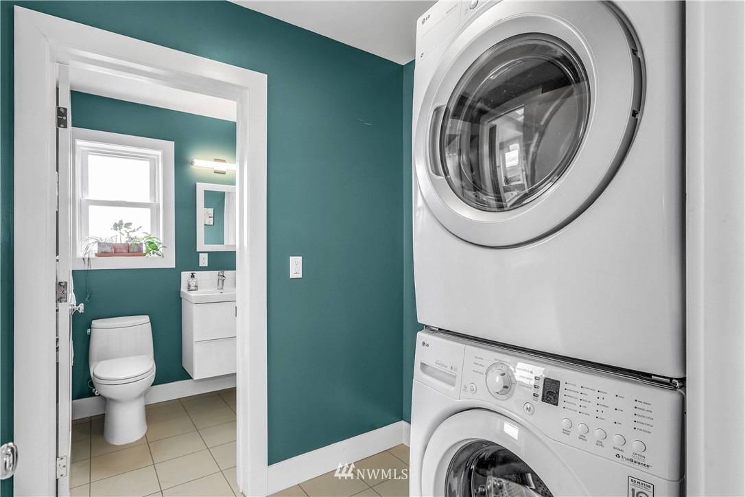 2418 East Roy Street Seattle, WA 98112 - Photo 22 of 32 a view of a bathroom with washing machine and sink