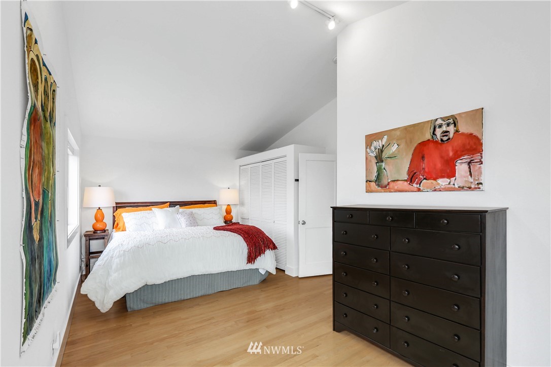 2418 East Roy Street Seattle, WA 98112 - Photo 24 of 32 a bedroom with a bed and a cabinet